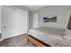 Bedroom with a standard bed frame, closet, and gray-tone tiled flooring at 6865 Steel Mist St, Las Vegas, NV 89148