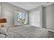 Bedroom with a window with white shutters, gray walls, and tiled floor at 6865 Steel Mist St, Las Vegas, NV 89148