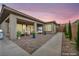 Beautiful covered patio featuring outdoor seating, dining area, pavers and stylish landscaping at 6865 Steel Mist St, Las Vegas, NV 89148
