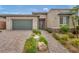Inviting single-story home featuring a well-maintained front yard and a welcoming entrance path at 6865 Steel Mist St, Las Vegas, NV 89148