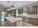 Stylish kitchen features a marble island, stainless steel appliances, and ample storage at 6865 Steel Mist St, Las Vegas, NV 89148