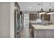 Open kitchen area with modern stainless appliances, stylish cabinets, and large center island at 6865 Steel Mist St, Las Vegas, NV 89148