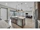 Spacious kitchen featuring a large island with sink and dishwasher, stainless appliances, and open floorplan at 6865 Steel Mist St, Las Vegas, NV 89148