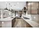 Open kitchen design with modern marble countertops, stainless appliances, stylish cabinets and pendant lighting at 6865 Steel Mist St, Las Vegas, NV 89148