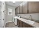 Modern laundry room featuring ample cabinet space, counter, sink, and a washer and dryer for added convenience at 6865 Steel Mist St, Las Vegas, NV 89148