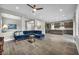 Inviting living room featuring wood-look tile flooring, with an open view of kitchen at 6865 Steel Mist St, Las Vegas, NV 89148