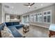 Bright living area with wood-look tile flooring and seamlessly connected to the modern kitchen at 6865 Steel Mist St, Las Vegas, NV 89148