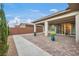 Spacious covered patio overlooking the backyard with manicured landscaping and brick pavers at 6865 Steel Mist St, Las Vegas, NV 89148