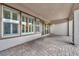 Covered patio featuring stone flooring, ample space, and multiple windows for natural light at 6865 Steel Mist St, Las Vegas, NV 89148