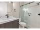Bathroom boasts white countertops, dark wood cabinets, and a frameless shower with black hardware at 7062 Maverick St, Las Vegas, NV 89131