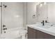 Bathroom featuring a double sink vanity, modern fixtures, and a tiled shower over tub at 7062 Maverick St, Las Vegas, NV 89131