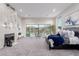 Stylish main bedroom with a fireplace, seating area, and large windows overlooking the backyard at 7062 Maverick St, Las Vegas, NV 89131