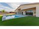 A backyard swimming pool and hot tub are surrounded by artificial turf at 7062 Maverick St, Las Vegas, NV 89131