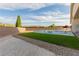 A backyard swimming pool and hot tub are surrounded by artificial turf at 7062 Maverick St, Las Vegas, NV 89131