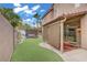 Backyard view showcasing the patio, lawn, and outdoor kitchen, perfect for outdoor living and entertainment at 7621 Hackensack Ct, Las Vegas, NV 89128