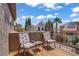 Outdoor balcony seating with a lovely view of neighboring homes and palm trees, offering a relaxing outdoor space at 7621 Hackensack Ct, Las Vegas, NV 89128