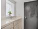 Bathroom featuring a ceramic sink and tile countertop at 7621 Hackensack Ct, Las Vegas, NV 89128