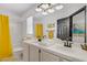 Bright bathroom featuring double sinks, a shower and tub combo with yellow accents adding a touch of color at 7621 Hackensack Ct, Las Vegas, NV 89128