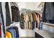 Organized walk-in closet with hanging racks, shelves, and a storage bench, maximizing storage space and convenience at 7621 Hackensack Ct, Las Vegas, NV 89128