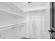 Well-organized walk-in closet with shelves, hanging rods, and a white robe, offering ample storage space at 7621 Hackensack Ct, Las Vegas, NV 89128