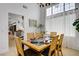 Cozy dining room with tile flooring, a modern light fixture, and a large window at 7621 Hackensack Ct, Las Vegas, NV 89128