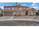 Elegant two-story home with a tile roof, desert landscaping, and a two-car garage at 7621 Hackensack Ct, Las Vegas, NV 89128