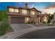 Charming home with a well-manicured lawn and a two-car garage, set against a beautiful sunset at 7621 Hackensack Ct, Las Vegas, NV 89128