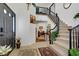 Bright foyer with tile flooring, a staircase with wrought iron railing, and views to other rooms at 7621 Hackensack Ct, Las Vegas, NV 89128