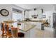 Bright kitchen featuring white cabinets, granite countertops, tile flooring, and a breakfast bar at 7621 Hackensack Ct, Las Vegas, NV 89128
