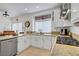 Bright kitchen with granite countertops, white cabinets, and stainless steel dishwasher at 7621 Hackensack Ct, Las Vegas, NV 89128