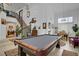 Open-concept living room with a pool table, high ceilings, and plenty of natural light at 7621 Hackensack Ct, Las Vegas, NV 89128