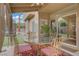 Covered patio featuring a round glass-top table with four chairs, ideal for outdoor dining and relaxation at 7621 Hackensack Ct, Las Vegas, NV 89128