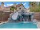 Close up of the custom pool showcasing the impressive rock slide and waterfall feature at 7621 Hackensack Ct, Las Vegas, NV 89128