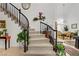 Bright foyer featuring staircase with wrought iron railing, and views to other rooms at 7621 Hackensack Ct, Las Vegas, NV 89128