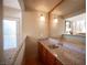 Stylish bar area with granite countertops, sink, and mirrored backsplash at 794 Oakmont Ave # 106, Las Vegas, NV 89109