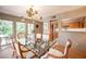 Formal dining room with glass table, stylish lighting, and view of the well-equipped kitchen at 794 Oakmont Ave # 106, Las Vegas, NV 89109