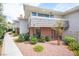 Charming exterior view with brick accents, patio seating, and well-maintained landscaping, creating an inviting appeal at 794 Oakmont Ave # 106, Las Vegas, NV 89109