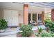 Inviting covered porch with double doors, brick pillars, and decorative landscaping for added curb appeal at 794 Oakmont Ave # 106, Las Vegas, NV 89109