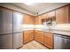 Well-equipped kitchen with stainless steel appliances, granite countertops, and wood cabinets at 794 Oakmont Ave # 106, Las Vegas, NV 89109