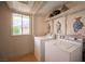Well-lit laundry room featuring a window and plenty of storage space at 794 Oakmont Ave # 106, Las Vegas, NV 89109