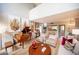 Inviting living room featuring a grand piano, stylish seating, and contemporary artwork at 794 Oakmont Ave # 106, Las Vegas, NV 89109