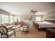 Large main bedroom with a cozy seating area, natural light, and fan at 794 Oakmont Ave # 106, Las Vegas, NV 89109