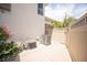 Small side patio with flowers, an AC unit, hose, and a partial view of the neighborhood at 794 Oakmont Ave # 106, Las Vegas, NV 89109