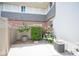 Small side patio with flowers, an AC unit, brick accents, and view of the neighbor's home at 794 Oakmont Ave # 106, Las Vegas, NV 89109