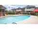 Serene community pool with lounge chairs and umbrella, providing a perfect spot for relaxation and leisure at 794 Oakmont Ave # 106, Las Vegas, NV 89109