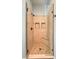 Glass-enclosed shower featuring tiled walls, tiled floor, and built-in shelving at 8216 Tursi Lodge Ct, Las Vegas, NV 89131