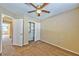 Neutral bedroom with a ceiling fan, carpet flooring, and a closet with shelving at 8231 Burnt Sienna St, Las Vegas, NV 89123