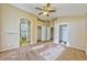 Bright bedroom with multiple closets, archways, and neutral carpeting at 8231 Burnt Sienna St, Las Vegas, NV 89123