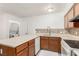 Galley kitchen features wood cabinets, neutral countertops and backsplash, and washer/dryer closet at 848 Hedge Way # 5, Las Vegas, NV 89110