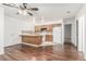 Open-concept kitchen with a breakfast bar, white appliances, and wood cabinetry at 848 Hedge Way # 5, Las Vegas, NV 89110